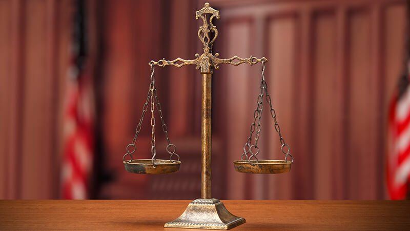 Criminal defense with scale of justice